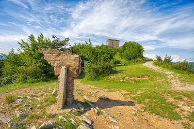 Old stone wall on field against sky