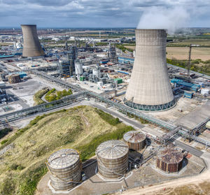 High angle view of smoke stack against sky