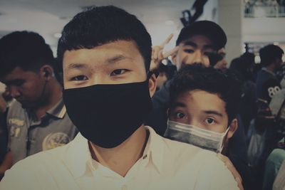 Portrait of men wearing pollution masks