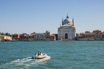 View of boats in sea against buildings