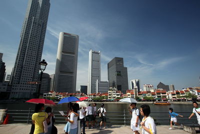 People in city against sky