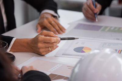 Midsection of business colleagues working at office