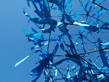 Low angle view of ferris wheel against blue sky