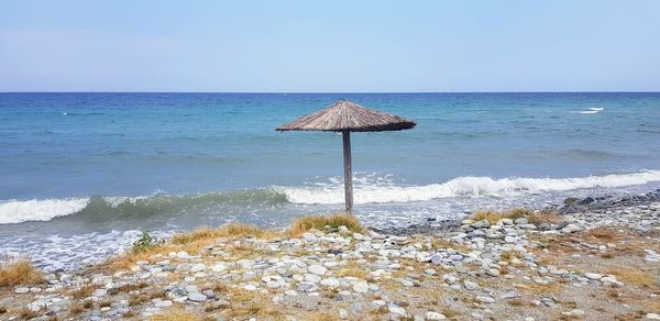 Lifeguard hut on beach against clear sky