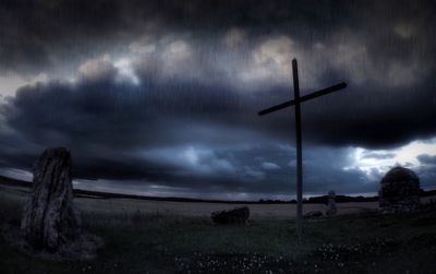 Windmill on field against cloudy sky