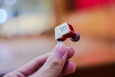 Close-up of hand holding eyeglasses against blurred background
