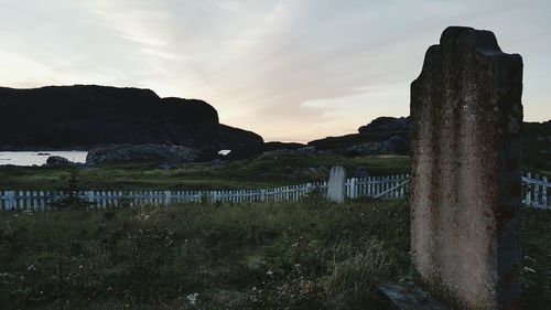 Scenic view of field against cloudy sky