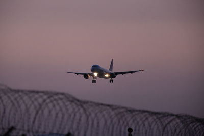 Low angle view of airplane flying against sky