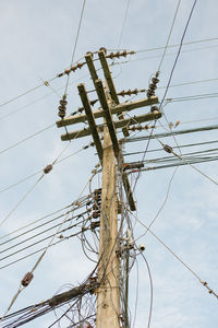 Low angle view of electricity pylon against sky