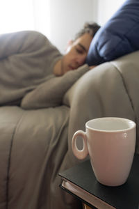 Midsection of woman using mobile phone at home