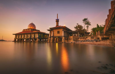 Reflection of building in water at sunset