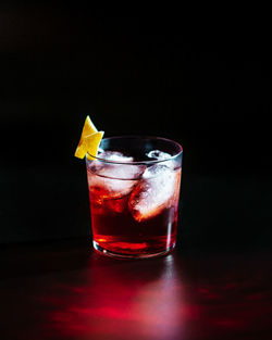 Close-up of drink in glass against black background