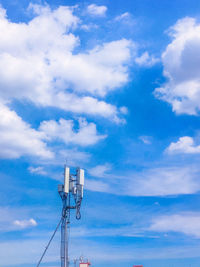 Low angle view of communications tower against sky