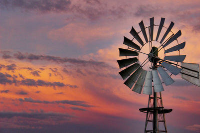 Low angle view of windmill against sky during sunset