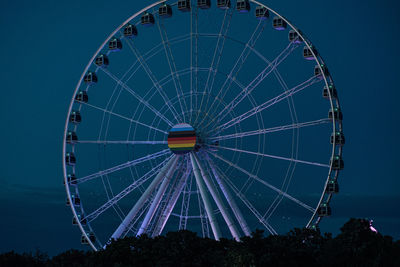 Low angle view of ferris wheel at night