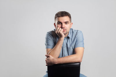 Portrait of young man against white background