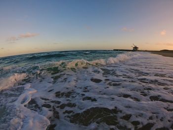 Scenic view of sea against clear sky during sunset