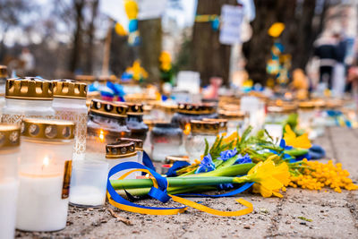 Thousands candles and flowers standing on the street during the war in ukraine