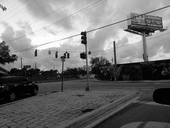 Cars on street against sky