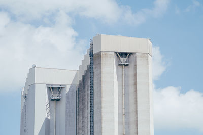 Low angle view of building against cloudy sky