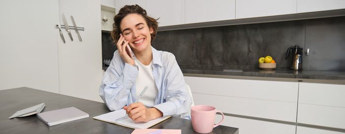 Portrait of young businesswoman working at home