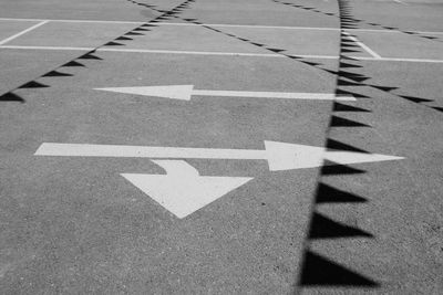 High angle view of road marking with shadow on street