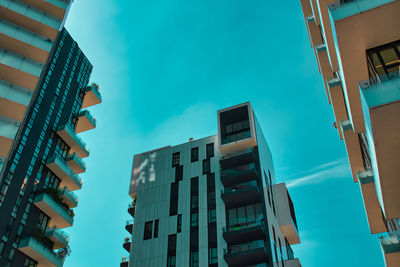 Low angle view of buildings against blue sky