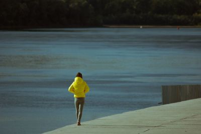 Rear view of woman standing on beach