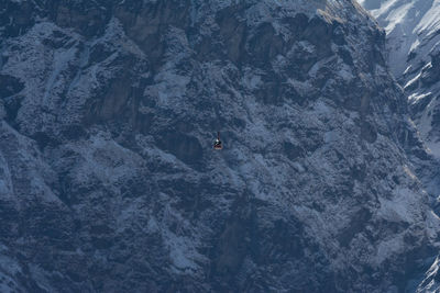 High angle view of helicopter against rock mountains