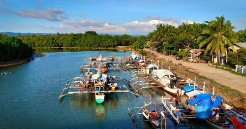 High angle view of boats moored in river against sky