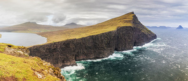 Scenic view of sea and mountain against sky