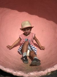 Portrait of young woman sitting at beach