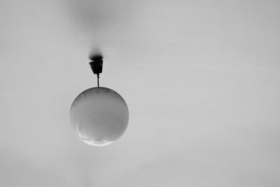 Low angle view of light bulb against white background