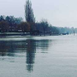 Calm lake against clear sky