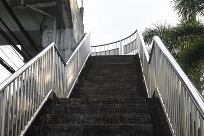 Low angle view of staircase by building against sky