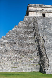 Low angle view of chichen itza against blue sky