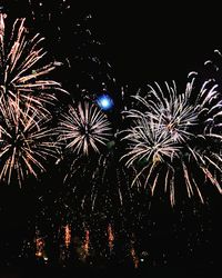 Low angle view of firework display at night