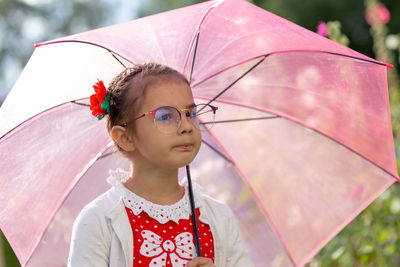 Portrait of a beautiful little girl with umbrella