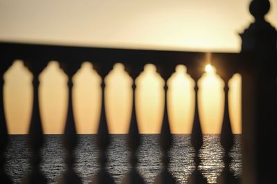 Close-up of illuminated bottle against calm sea