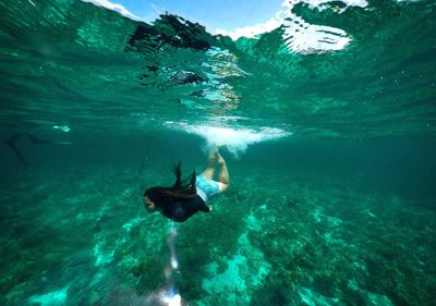 Woman swimming undersea