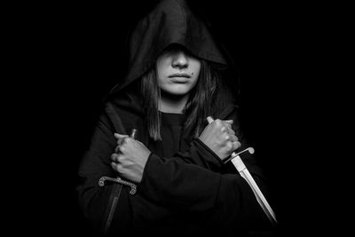 Portrait of a beautiful young woman over black background