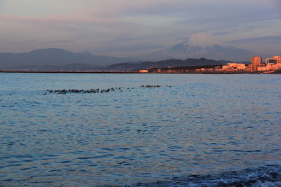 Scenic view of lake against sky at sunset