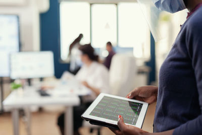 Midsection of man using laptop