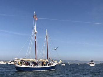 Sailboat sailing on sea against sky