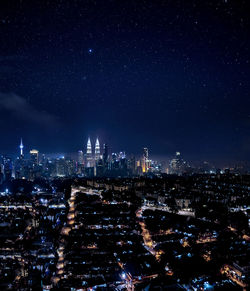 Aerial view of city lit up at night