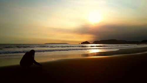 Scenic view of beach against sky during sunset