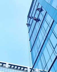 Low angle view of modern building against clear blue sky