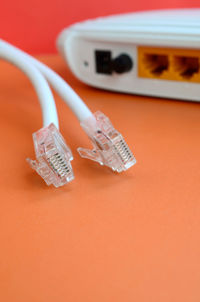 Close-up of computer network cables and router on table