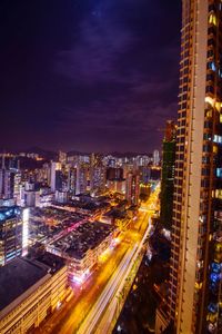 High angle view of illuminated buildings against sky at night