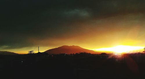 Silhouette mountains against sky at sunset